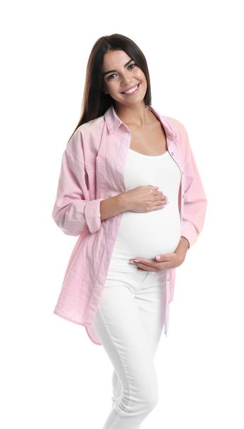 Happy pregnant woman holding her belly on white background - Foto, Imagen