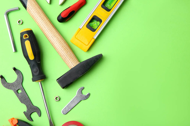 Set of repair tools on light green background, flat lay. Space for text - Foto, afbeelding