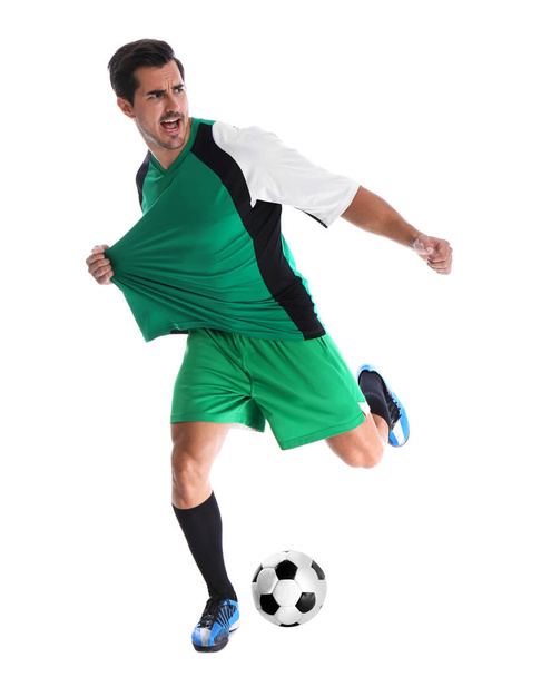 Young man playing football on white background - 写真・画像
