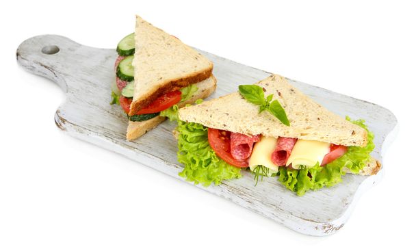 Tasty sandwiches with salami sausage and vegetables on cutting board, isolated on white - Foto, afbeelding