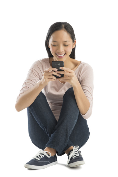 Happy Woman Text Messaging Through Mobile Phone - Φωτογραφία, εικόνα