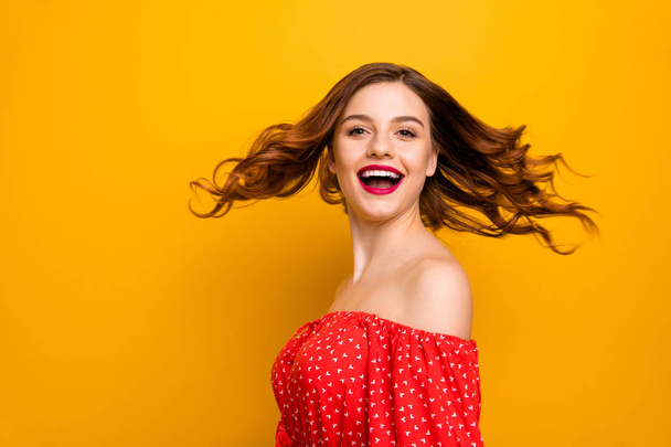 Pretty lady enjoy amazing weather and warm spring breeze wear red dress isolated yellow background - Foto, Imagem