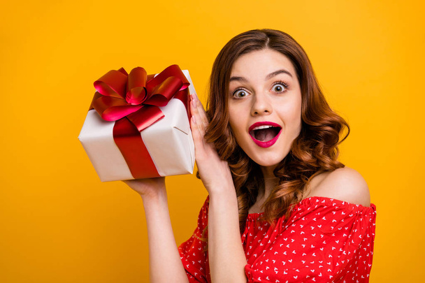 Beautiful foxy lady hold arms big giftbox want open ribbon wear dress isolated yellow background - 写真・画像