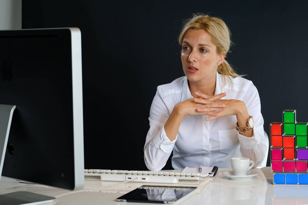 Beautiful blond hair business woman working in office, sitting at desk with cup of coffee  - Valokuva, kuva
