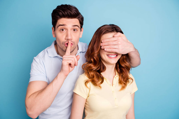 Photo of pair romance moment hide eyes finger mouth please be silent symbol request wear casual t-shirts isolated blue background - Photo, image