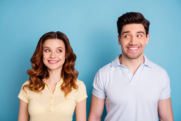 Close up photo of two pair people funky mood look each other silly expression rumours wear casual t-shirts isolated blue background - Fotó, kép