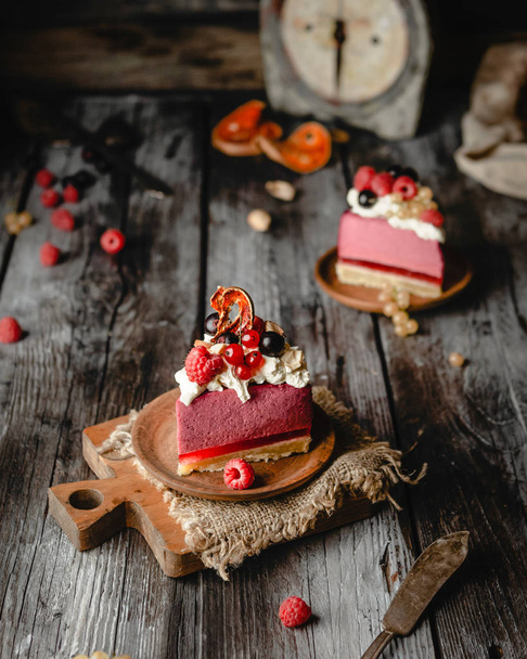 Slices of Homemade Berry cheesecake decorated with fresh berries on old wooden table  - Foto, imagen