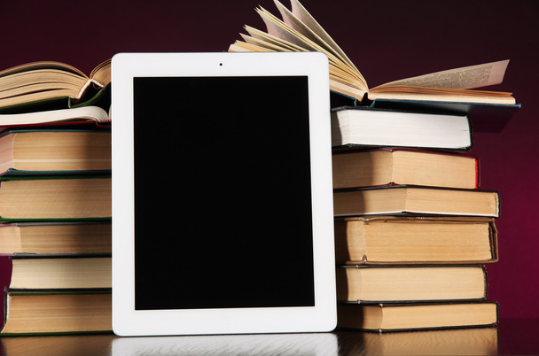 Tablet and books on bright background - Photo, Image