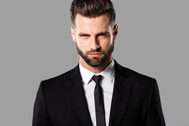 angry handsome businessman in black suit isolated on grey - Foto, immagini