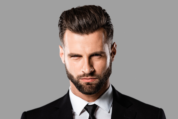 portrait of angry handsome businessman in black suit isolated on grey - Photo, Image