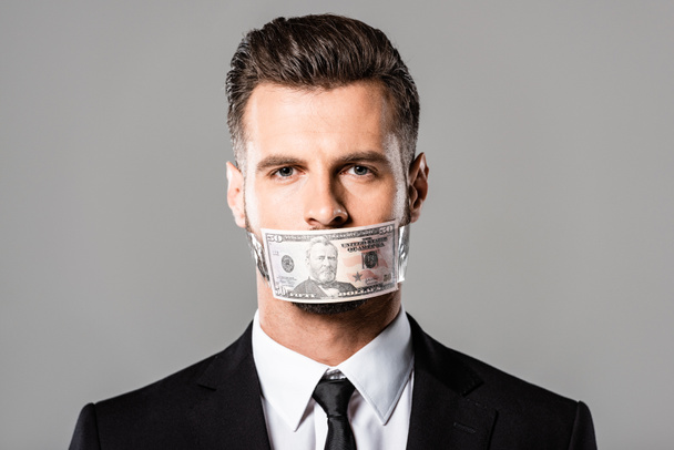 businessman with dollar banknote on mouth isolated on grey - Photo, image