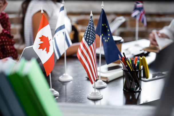 selective focus of flags of america, canada, european union and israel  - Foto, afbeelding