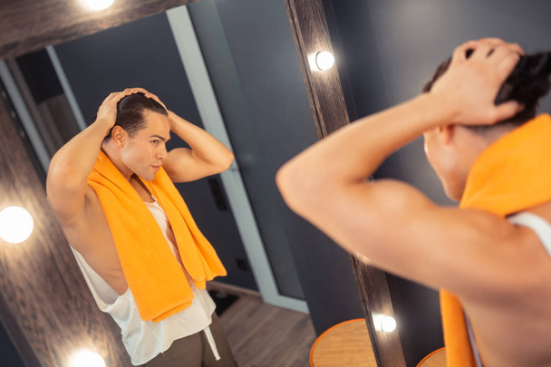 Nice handsome man posing near the mirror - Фото, изображение