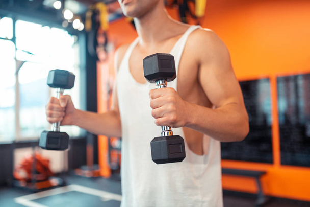 Selective focus of a dumbbell in male hands - Photo, image