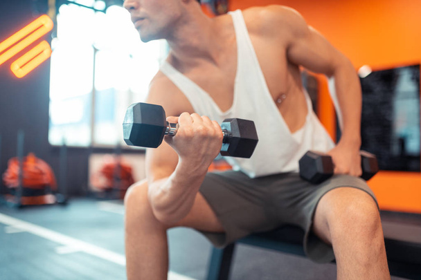 Selective focus of a dumbbell being in use - Foto, Imagem
