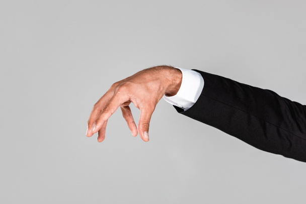cropped view of businessman grabbing hand isolated on grey - 写真・画像
