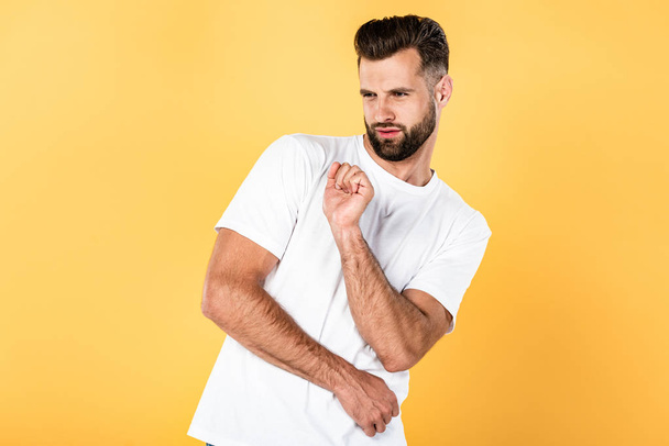 handsome man in white t-shirt dancing isolated on yellow - Foto, immagini