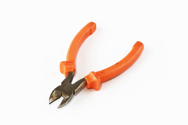 old rusty pliers tools, metal cutting pliers with orange handle - Photo, Image