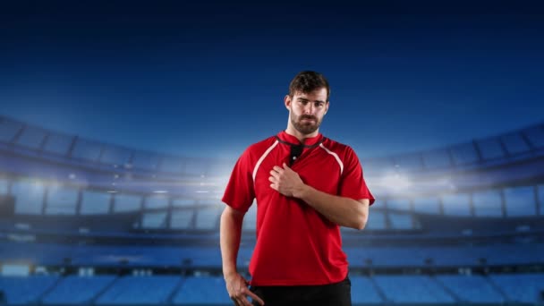 Animation of a Caucasian male rugby player standing with hands on his hips and looking to camera with floodlit stadium in the background - Video, Çekim