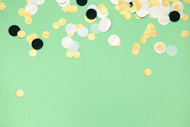 foil confetti sparse on trendy mint colored background - Foto, afbeelding