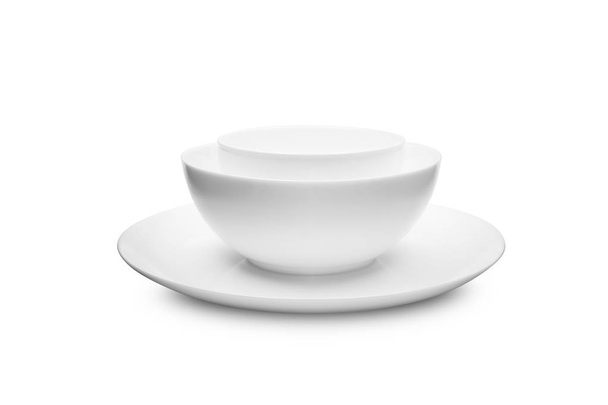 Set of white dishes on table on light background. - Foto, Imagen