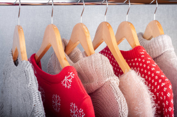 Warm sweaters. Female clothes on open clothes rail. Sale and sho - Photo, Image
