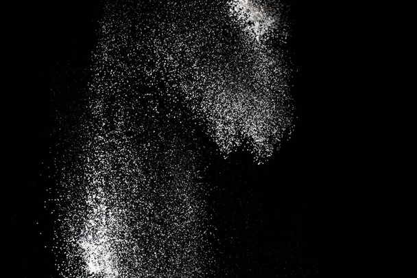 White powder splash isolated on black background. Flour sifting  - Photo, Image