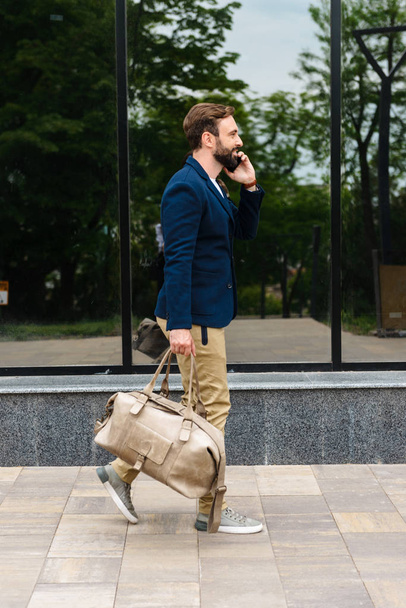 Attractive young bearded man wearing jacket walking - Fotografie, Obrázek