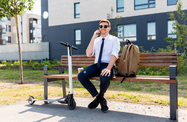 businessman with scooter calling on smartphone - Zdjęcie, obraz