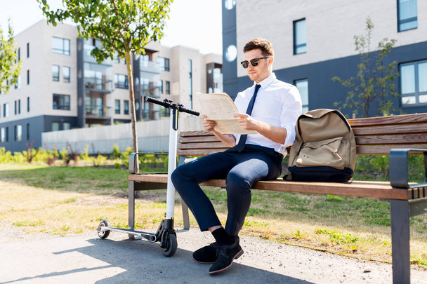 businessman with scooter reading newspaper in city - Zdjęcie, obraz