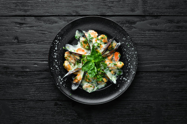 Mussels in cream sauce with basil. In the old background. Top view. Free copy space. - Photo, Image