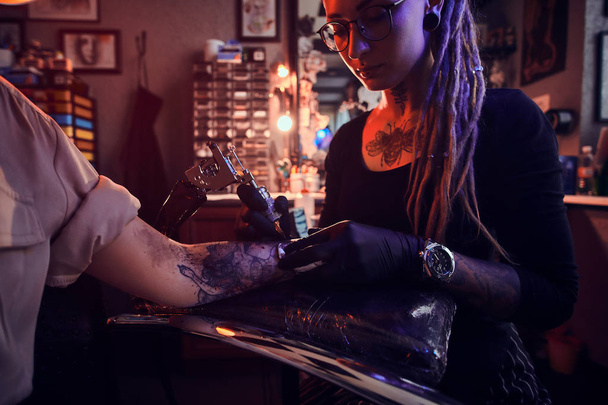Process of tattoo makining at cozy tattoo salon - Photo, image