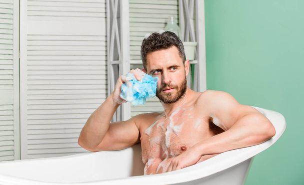 Clear skin. man wash muscular body with foam sponge. hygiene and health. Morning shower. personal care. Sexy man in bathroom. desire and temptation. macho man washing in bath - Photo, Image