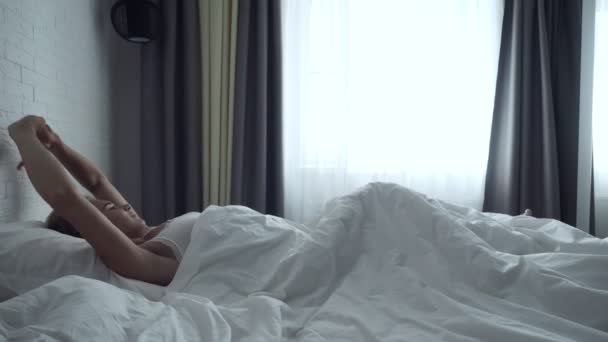 Young woman awakening and streches after sleep. - Filmagem, Vídeo