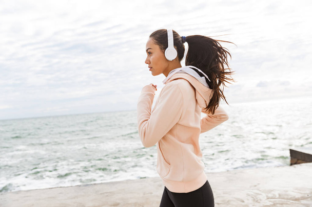 Attractive young asian fitness woman jogging - Photo, Image