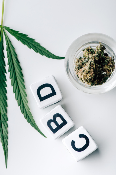 top view of cubes with lettering cbd, medical cannabis and marijuana on white background  - Fotó, kép