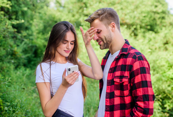 Do not peep. Man picky jealous girlfriend messaging online. Buy online. Internet dependence. Guy and girl nature smartphone. She always online. Mobile addicted. Social networks. Surfing internet - Фото, зображення