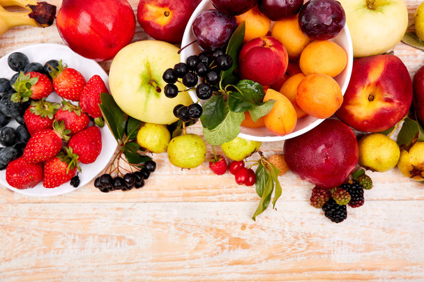 Flat lay of fruits over white wooden background - Foto, immagini