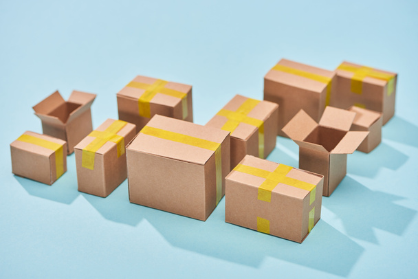cardboard boxes on blue background with copy space - Fotó, kép