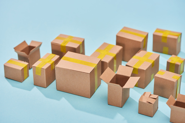 postal cardboard boxes on blue background with copy space - Photo, Image