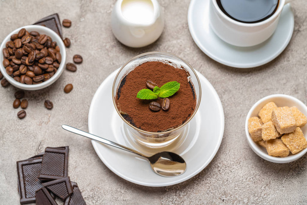 Classic tiramisu dessert in a glass, coffee, chocolate, cream and sugar on concrete background - Φωτογραφία, εικόνα