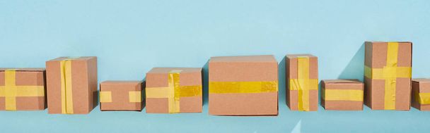 panoramic shot of miniature postal boxes on blue background - Foto, Imagen