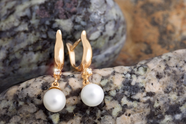 Gold Earrings with Diamonds and Pearls on the natural stones bac - Fotografie, Obrázek