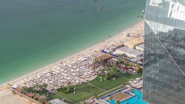 Waterfront overview Jumeirah Beach Residence JBR skyline aerial timelapse with yacht and boats - Foto, Imagen