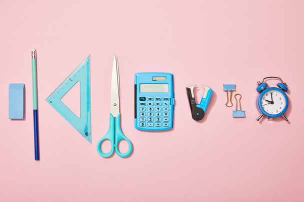 flat lay with blue school supplies isolated on pink - Fotoğraf, Görsel