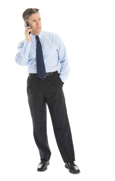 Businessman Looking Away While Answering Smart Phone - Photo, Image
