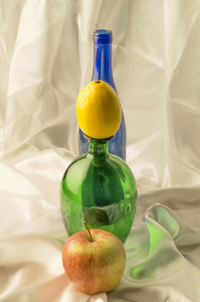 Bottle and fruits on a light background - Photo, image