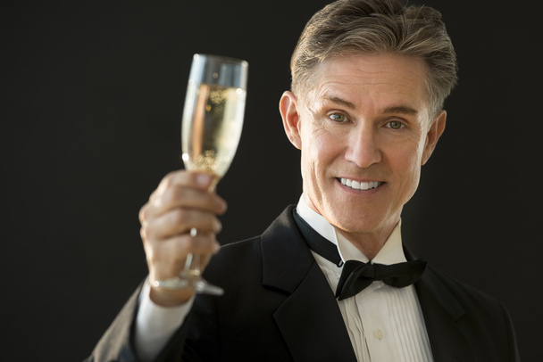 Happy Man In Tuxedo Holding Champagne Flute - Fotó, kép