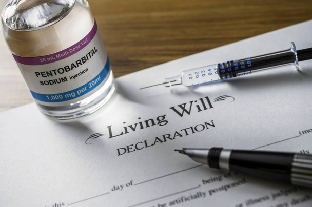 Living will declaration form Next to a vial of pentobarbital sodium to proceed to euthanasia, conceptual image - Photo, Image