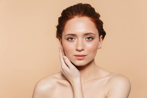 Amazing young redhead woman posing isolated over beige wall background. - Фото, зображення
